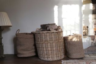A group of three log or storage baskets,