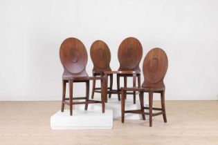 A set of four George III mahogany hall chairs,