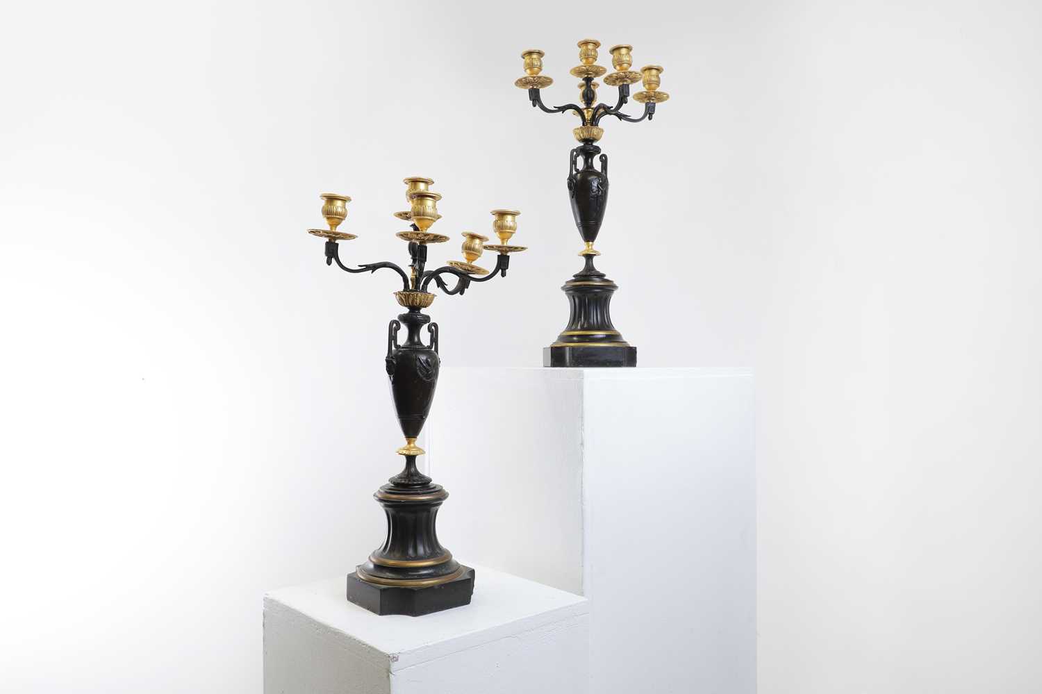 A pair of neoclassical-style patinated bronze and ormolu-mounted candelabra,