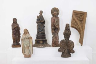 A group of carved wood saints and architectural fragments,