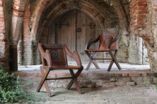 A pair of carved oak Glastonbury chairs,