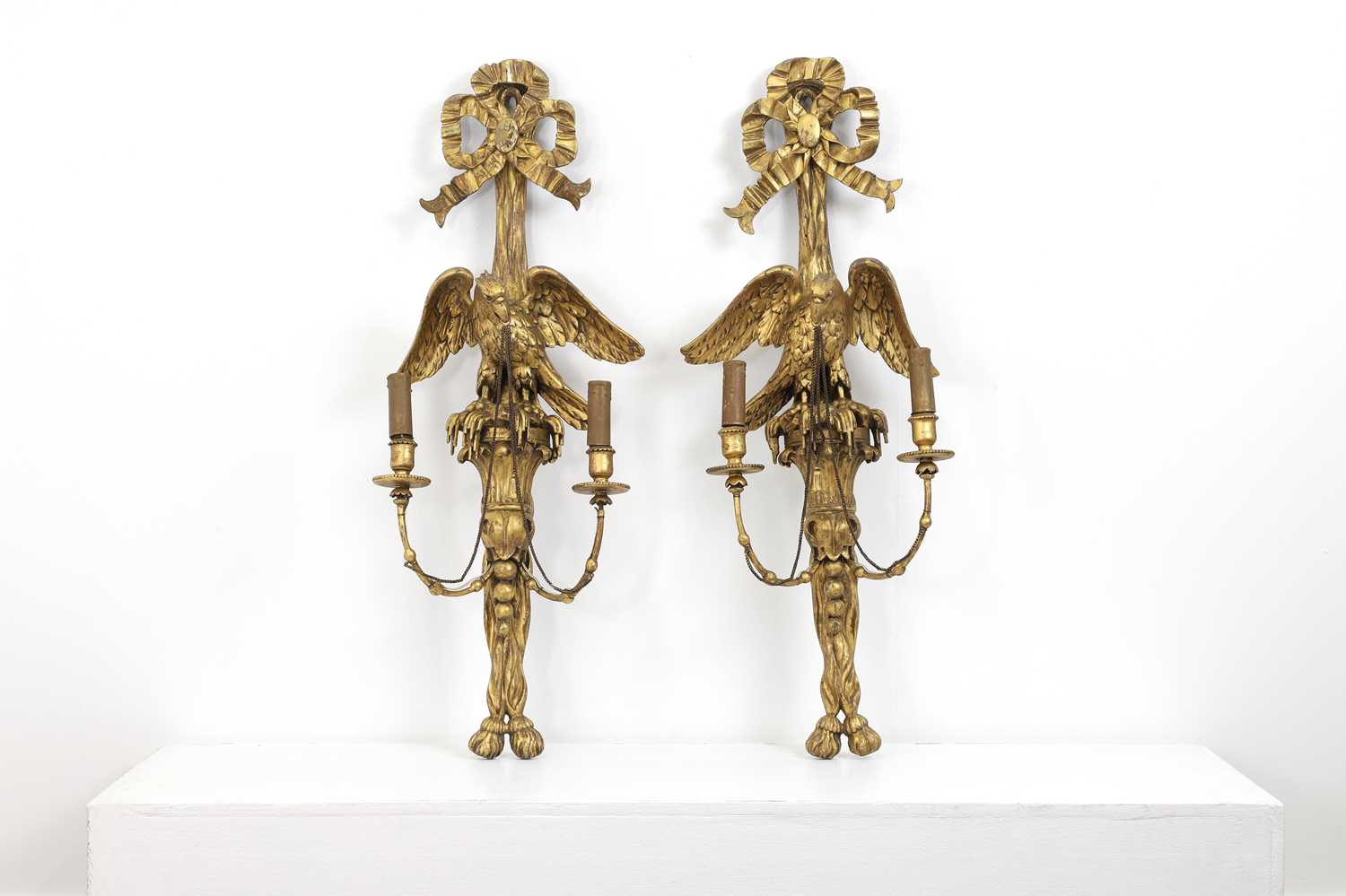 A pair of neoclassical-style carved giltwood wall lights,