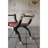 A Regency-style ebonised stool,