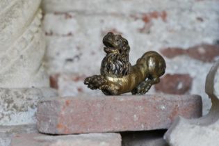 A gilt-bronze recumbent lion,