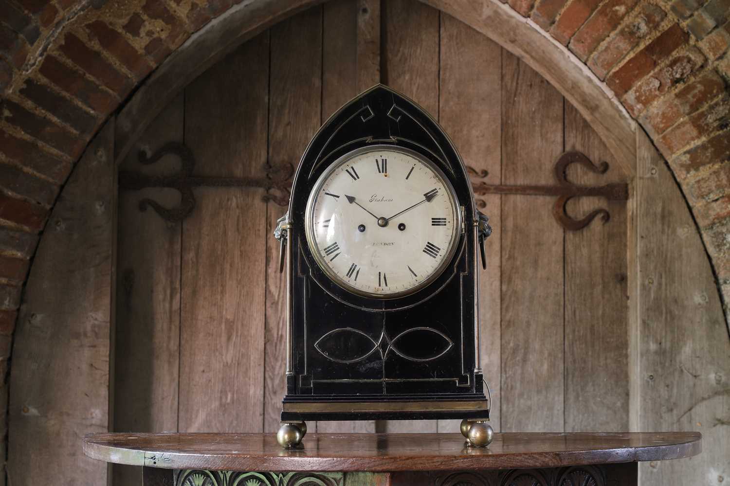A Regency ebonised table clock,