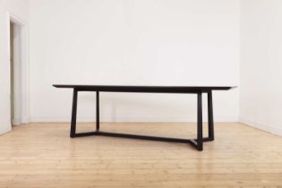 An ebonised dining table