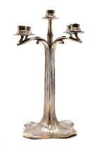 An Art Nouveau polished pewter candelabrum,