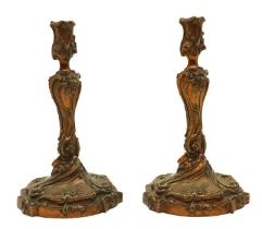 A pair of gilt bronze candlesticks in the Louis XV style