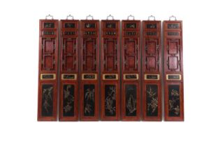 A set of eight stained wooden, lacquered and gilt panels,
