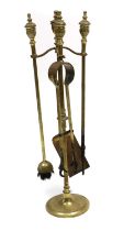 A set of brass fire tools and stand,