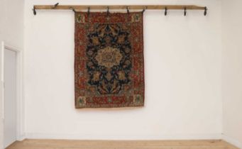 A Persian wool and silk rug,
