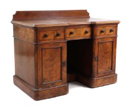 A Victorian walnut breakfront pedestal desk,