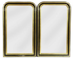 A pair of gilt and ebonised wall mirrors,