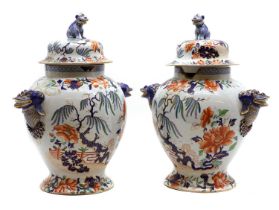 A pair of Stone China baluster vases and covers,