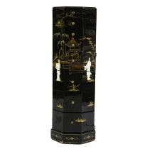 A black lacquered Chinoiserie octagonal bank of drawers