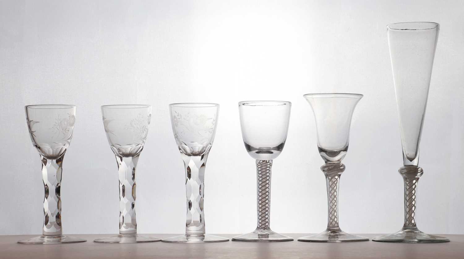 A set of three 18th century style facet cut wine glasses,