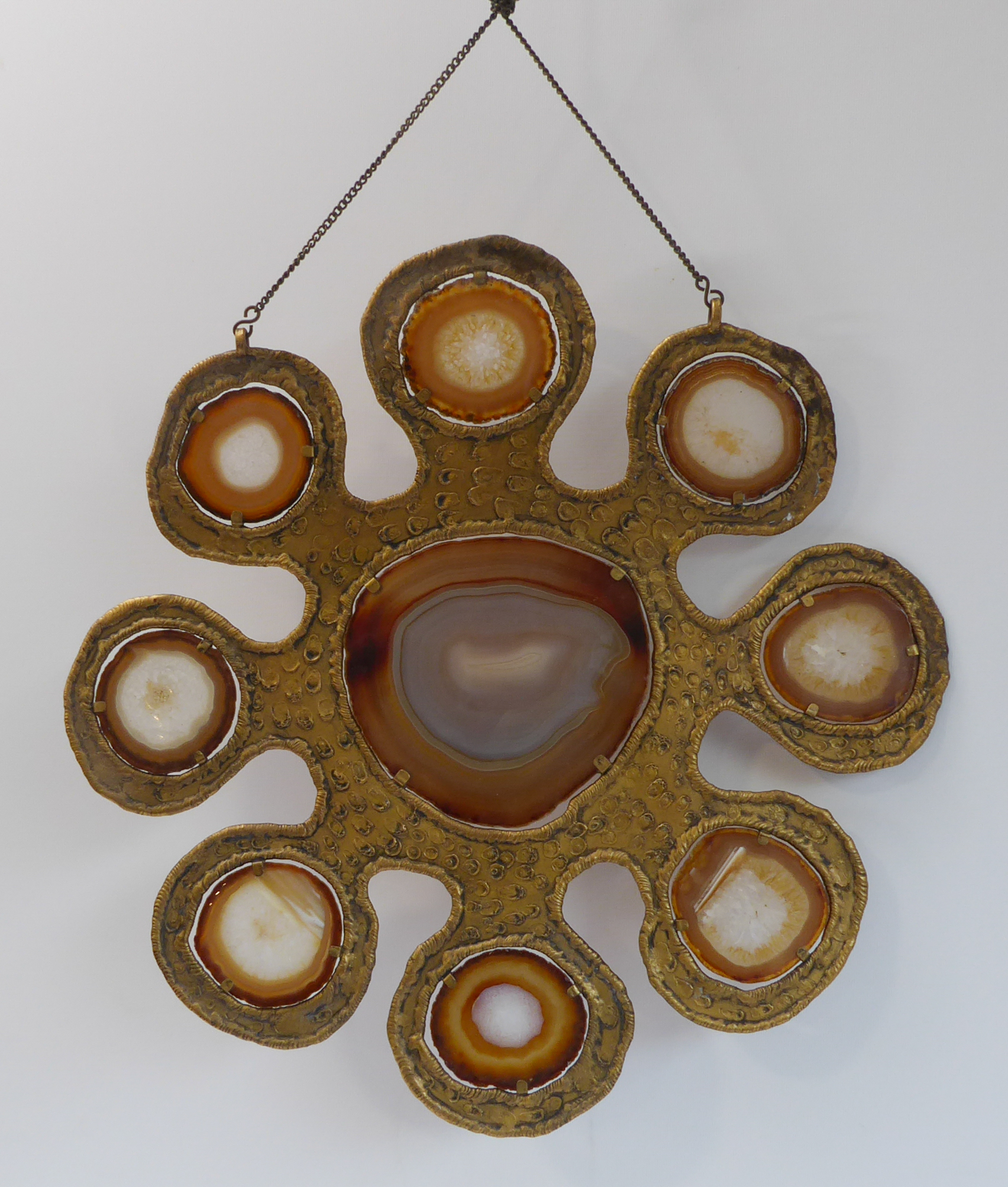 A 1970s gilt-metal hanging mobile, set with a large central agate panel surrounded by eight