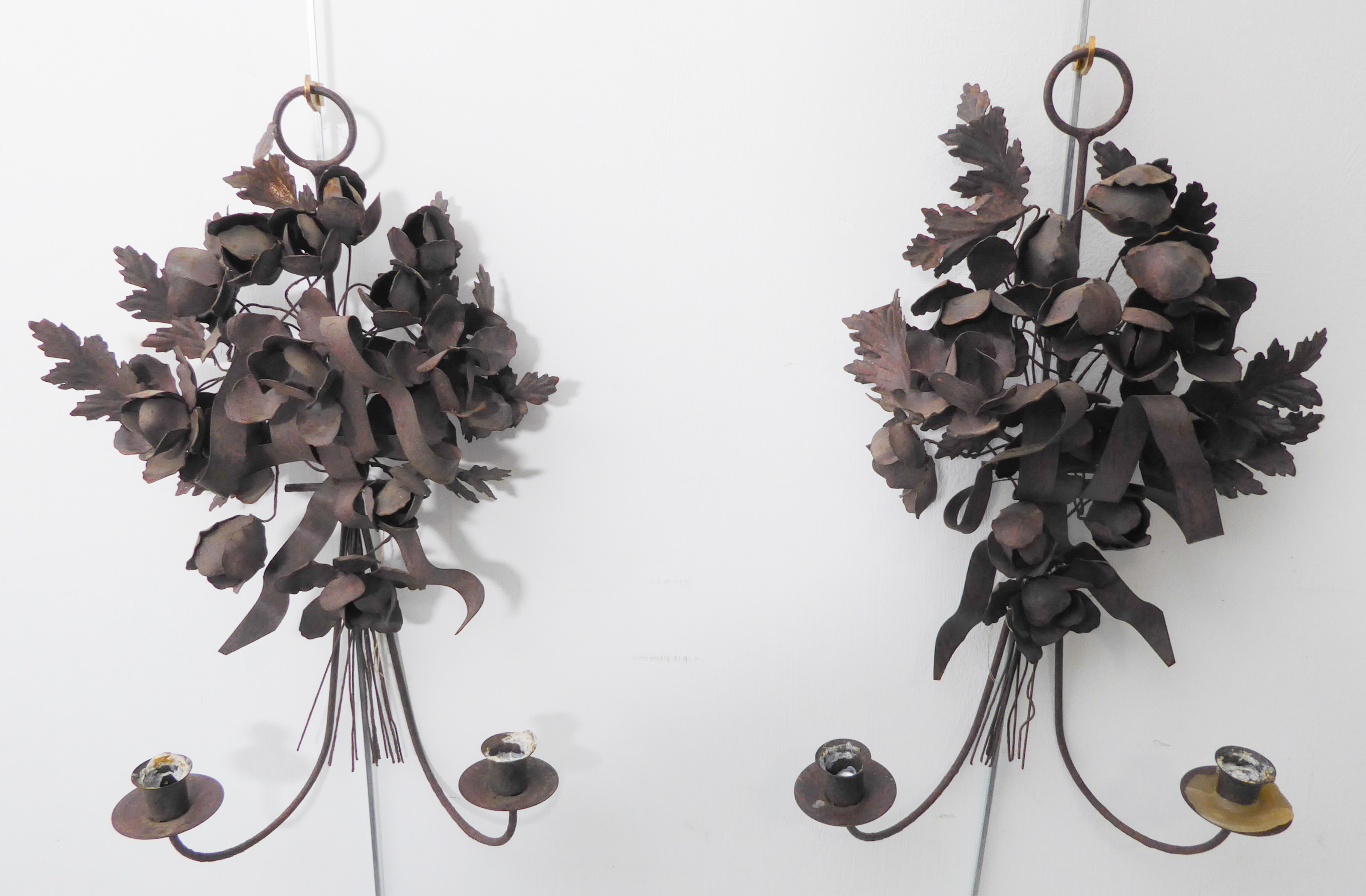 A pair of two-light wall sconces with handmade metal flowers above the candle holders (46 cm high)