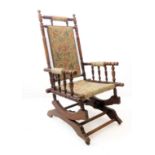 An American-style, late 19th century floral upholstered and walnut rocking chair