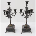 A pair of late 19th century brass and marble four-light candelabra: the gilt-picked marble bases