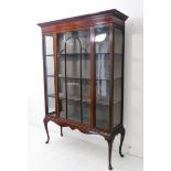 An Edwardian mahogany and boxwood-strung display cabinet: the slender dentil cornice above frieze