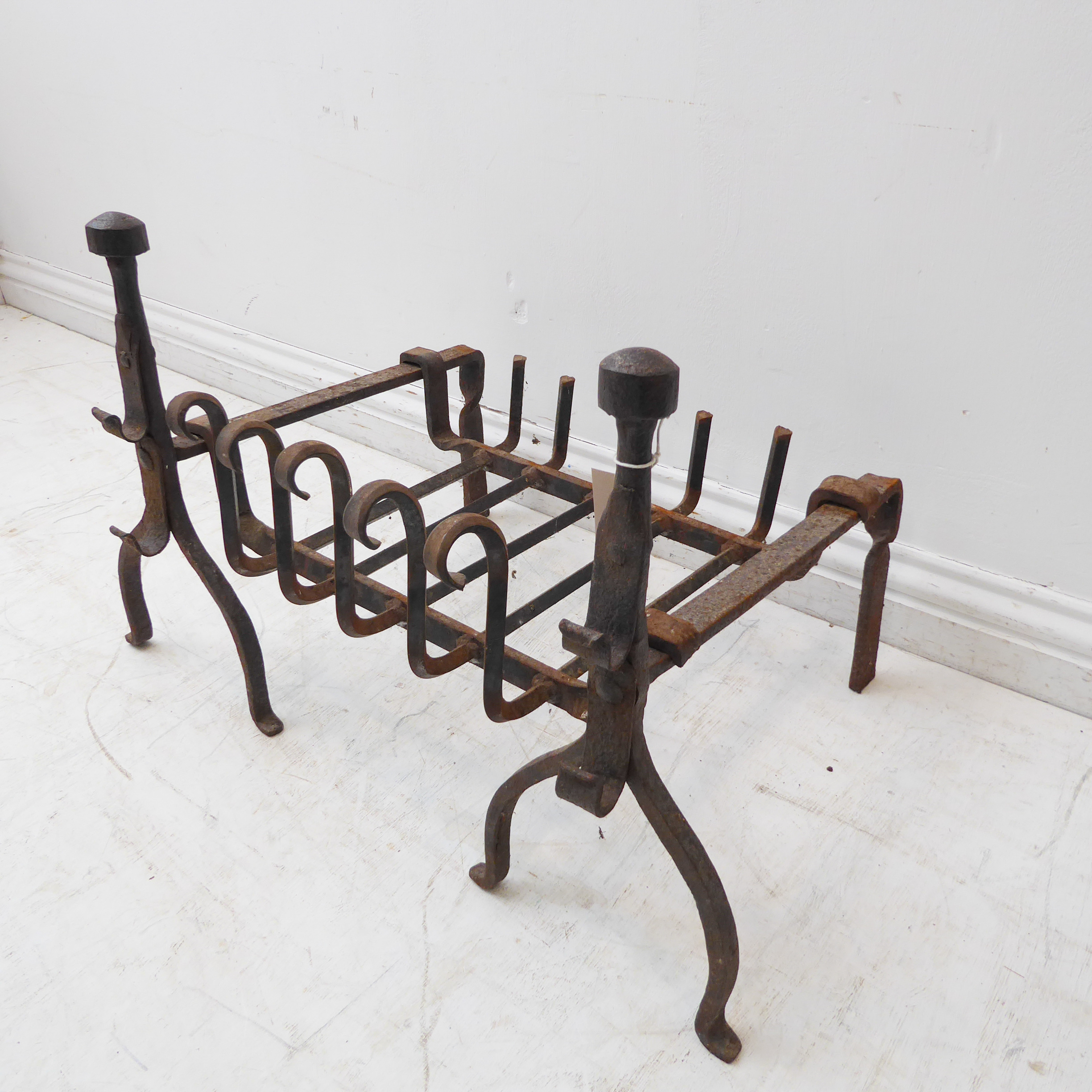 A 20th century blacksmith-made iron dog-grate and a pair of iron firedogs with iron rests and