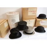 Three top hats (two black one grey) and two bowlers, all in their maker's boxes: Lock & Co. top hat;