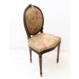 A 19th century French carved-walnut salon chair upholstered in Bennison fabric and in Louis XVI