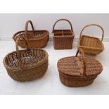 Five wicker baskets to include a bottle-carrier