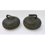 A pair of old granite curling stones (one handle at fault).
