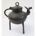 An Indian circular ring lidded bronze vessel of cauldron form, with a loop handle and supported on