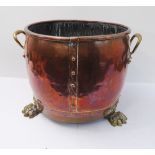 A 19th century circular copper log-bin with brass loop-handles and riveted copper borders, raised on