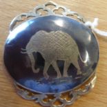 A Thai style silver mounted brooch centrally decorated with an engraved elephant (boxed)