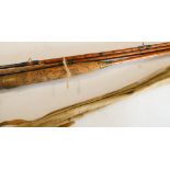 Two vintage cane fly fishing rods with cloth cases.