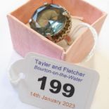 A lady's Fiorelli silver ring set with a large, single, hand-cut light blue/purple stone (boxed)