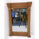 A pine pier glass; outset split turned moulded columns flanking mirror plate (53 cm wide x 76 cm