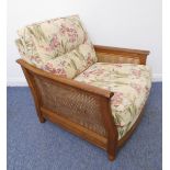 A matching Ercol single armchair (matches lots 453 and 454): rich coloured elm and rattan-caned