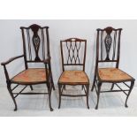 Three Edwardian mahogany and boxwood-strung chairs to include one carver