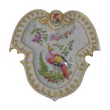 A 20th century Chelsea-style shield-form dish with hand-painted exotic bird and floral decoration