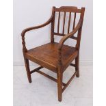 An early 19th century open-armed oak carver chair on square tapering front legs