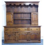 A good solid oak reproduction dresser in 18th century style: the dentil cornice above a wavy pierced