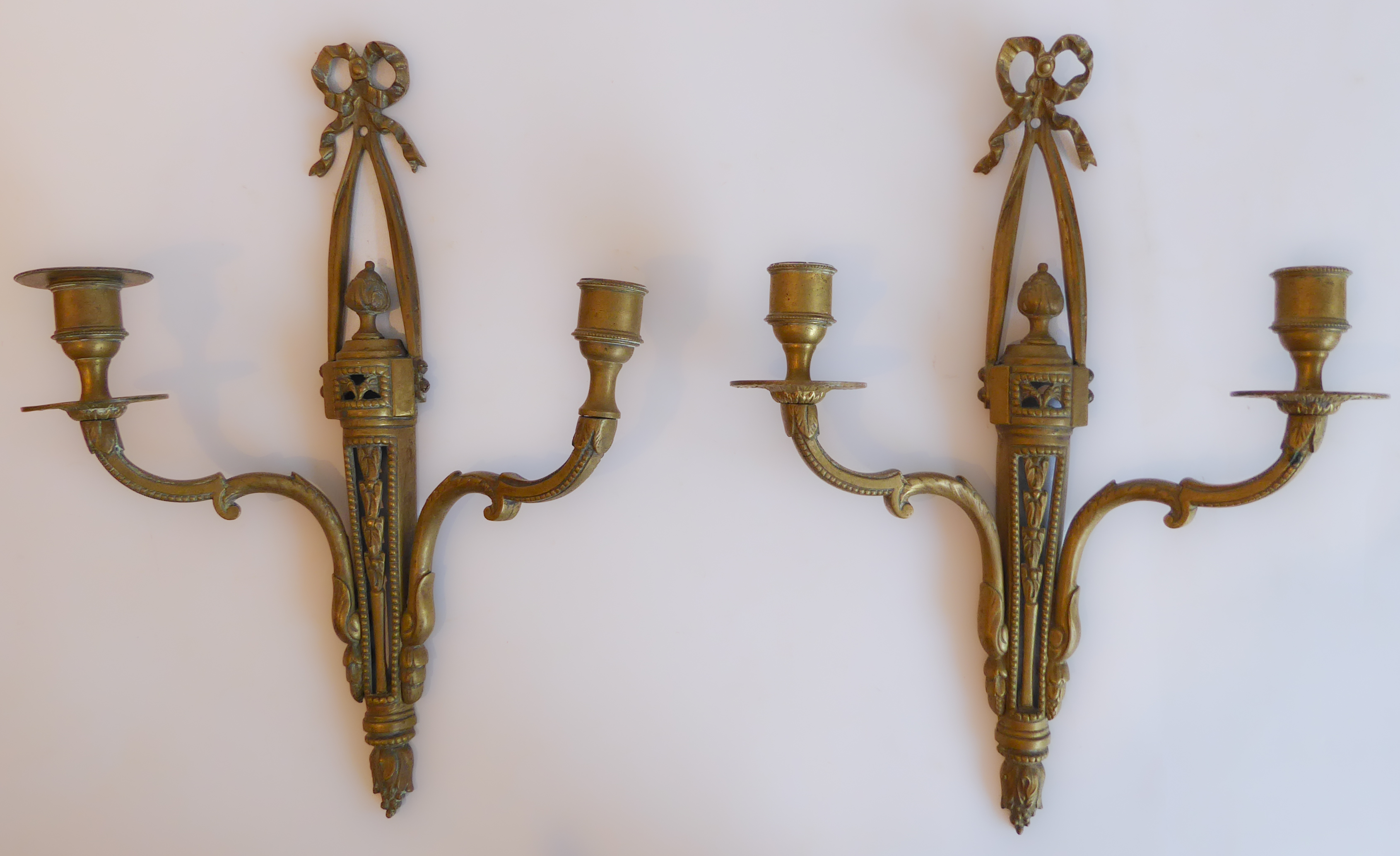 A pair of early 20th century two-light brass wall appliques in Louis XVI style (37 cm high)