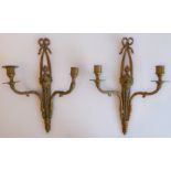 A pair of early 20th century two-light brass wall appliques in Louis XVI style (37 cm high)
