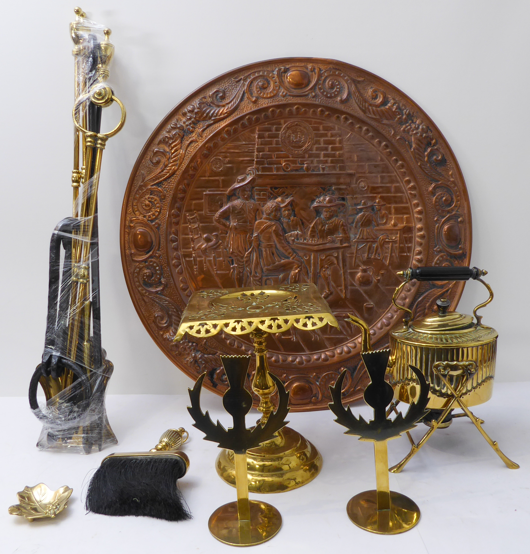 An assortment of metalware to include: an early 20th century brass trivet; a 19th century spirit-