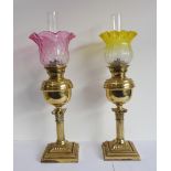 A pair of late 19th / early 20th century brass oil lamps modelled as short Corinthian columns with
