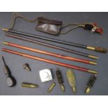 Mostly vintage gun cleaning equipment: a J. Purdey & Son oil bottle; two cleaning rods; a pocket