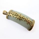 A Chinese light celadon jade pendant of convex form: yellow-metal mounted (stamped '375' to the