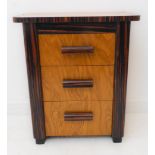 A oak and calamander three-drawer bedside cabinet in high Art Deco style (modern): the overhanging