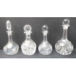 Three hand-cut globe-and-shaft decanters and a smaller hand-cut mallet-shaped decanter (4)