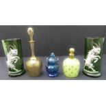 Two 19th century green glass vases modelled and decorated in relief with striding horn goats, a